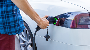men charging a  car